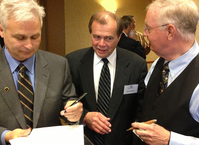 Image of signing of MU-UMCOE Foundation affiliation document by Thomas Hiles, Vice Chancellor for Advancement, COE Dean James Thompson, and Foundation President Ward Chambers, on May 8, 2013.